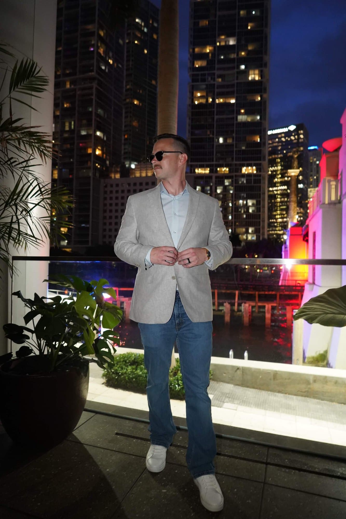 ZackMeta (@zackmetax) on a night balcony in a light blazer, open shirt, and jeans