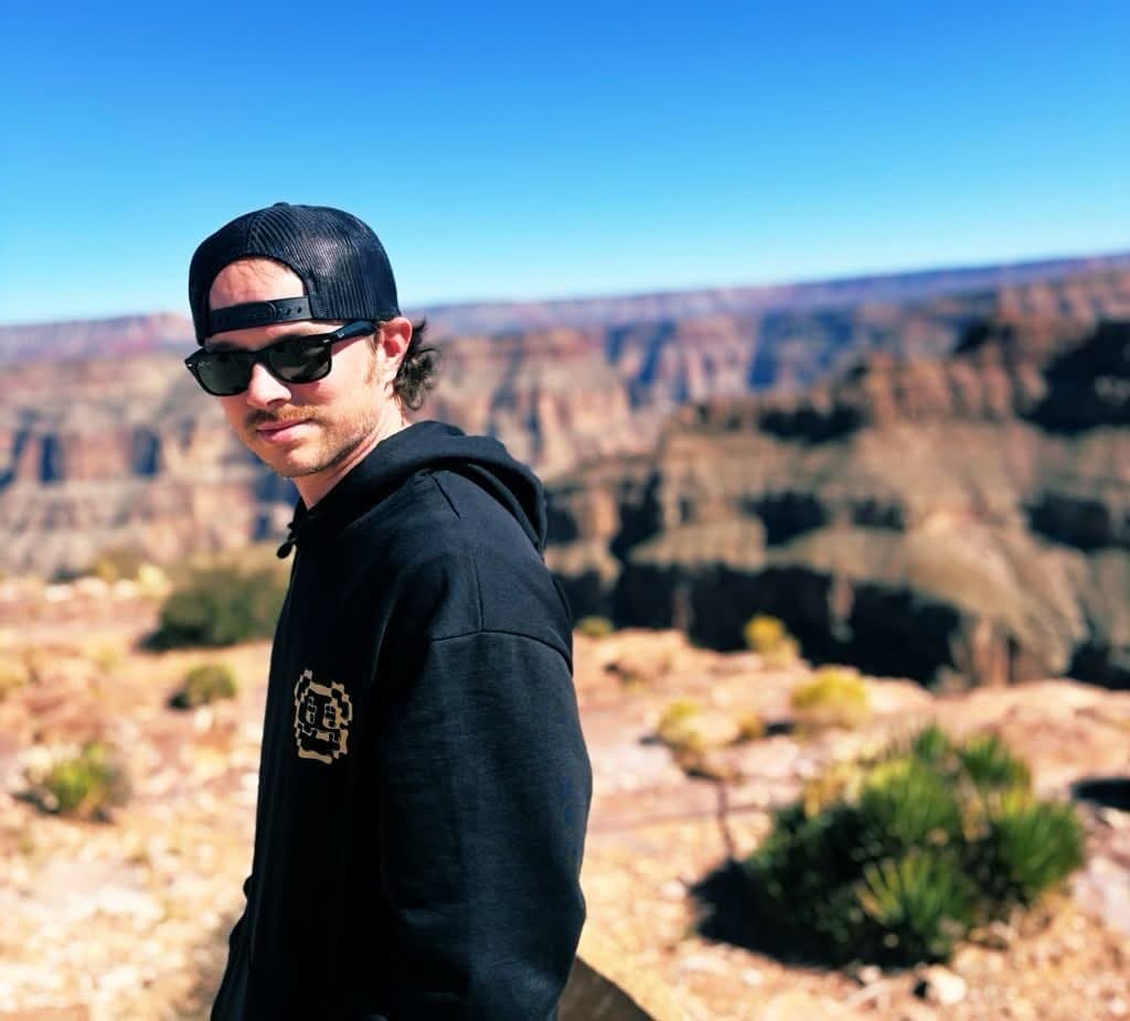 ZackMeta (@zackmetax) in a black hoodie and sunglasses at a canyon overlook