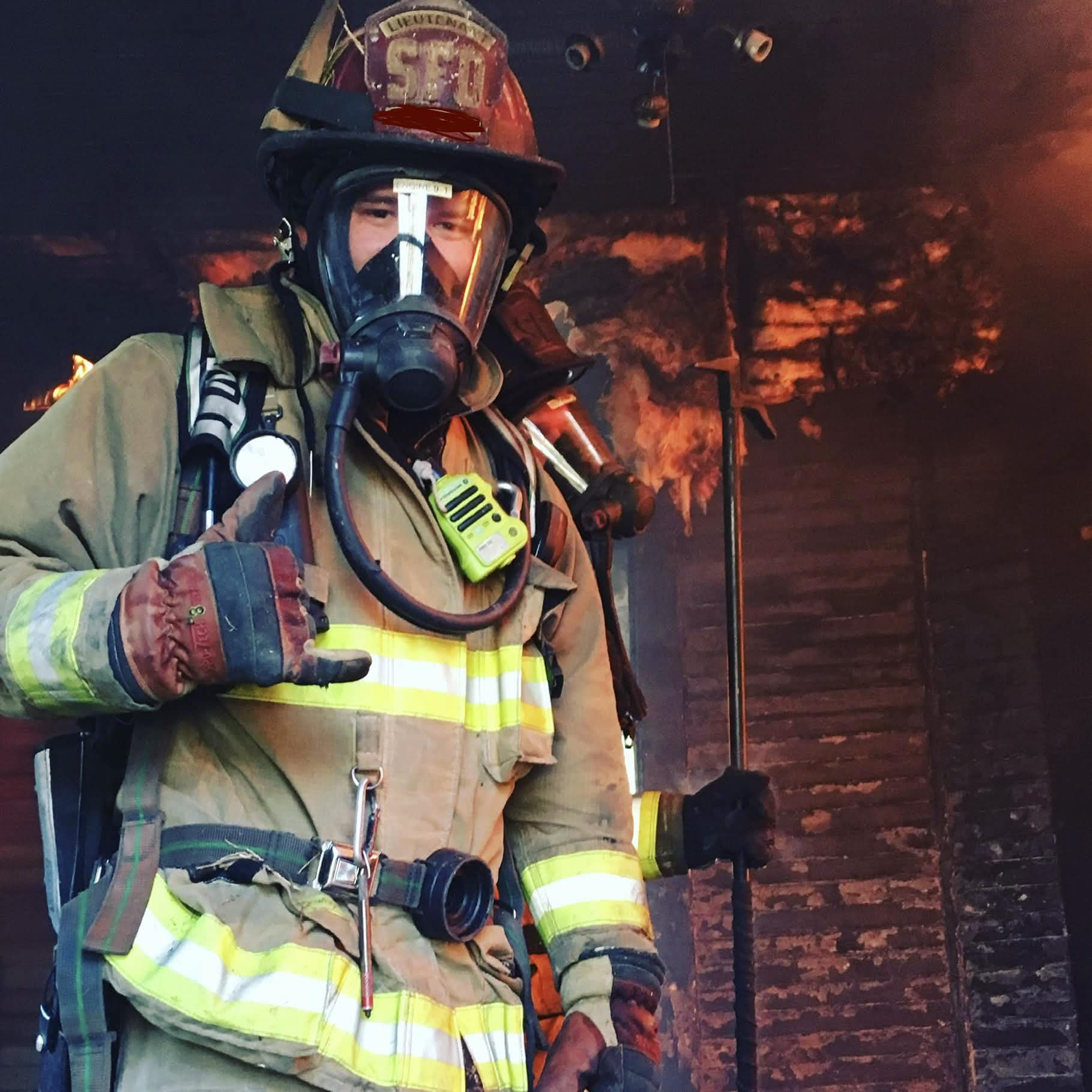 Zack as a firefighter in turnout gear and SCBA, helmet nameplate redacted